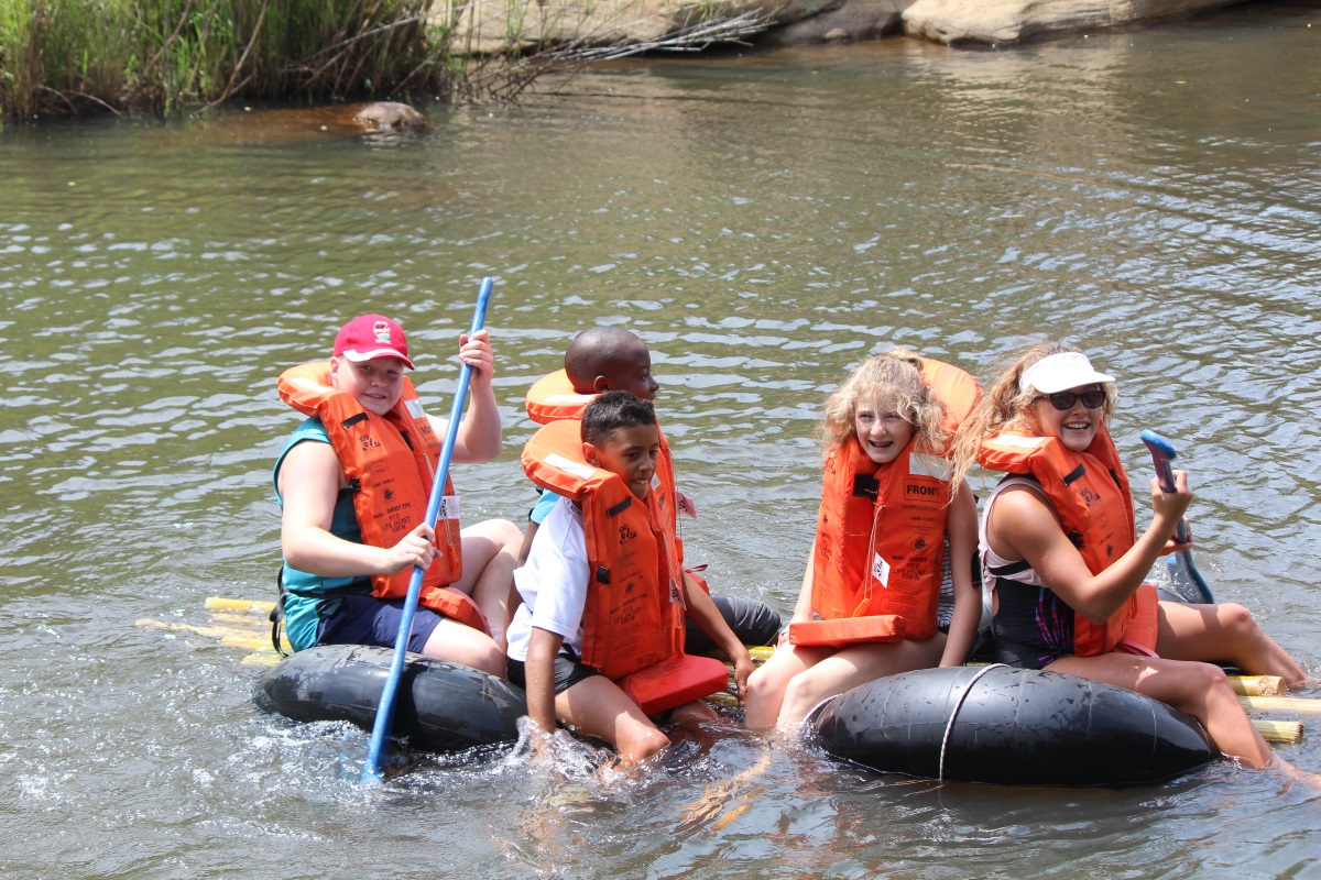 Grade 7 Monitors in the raft they had to construct and safely navigate across the dam